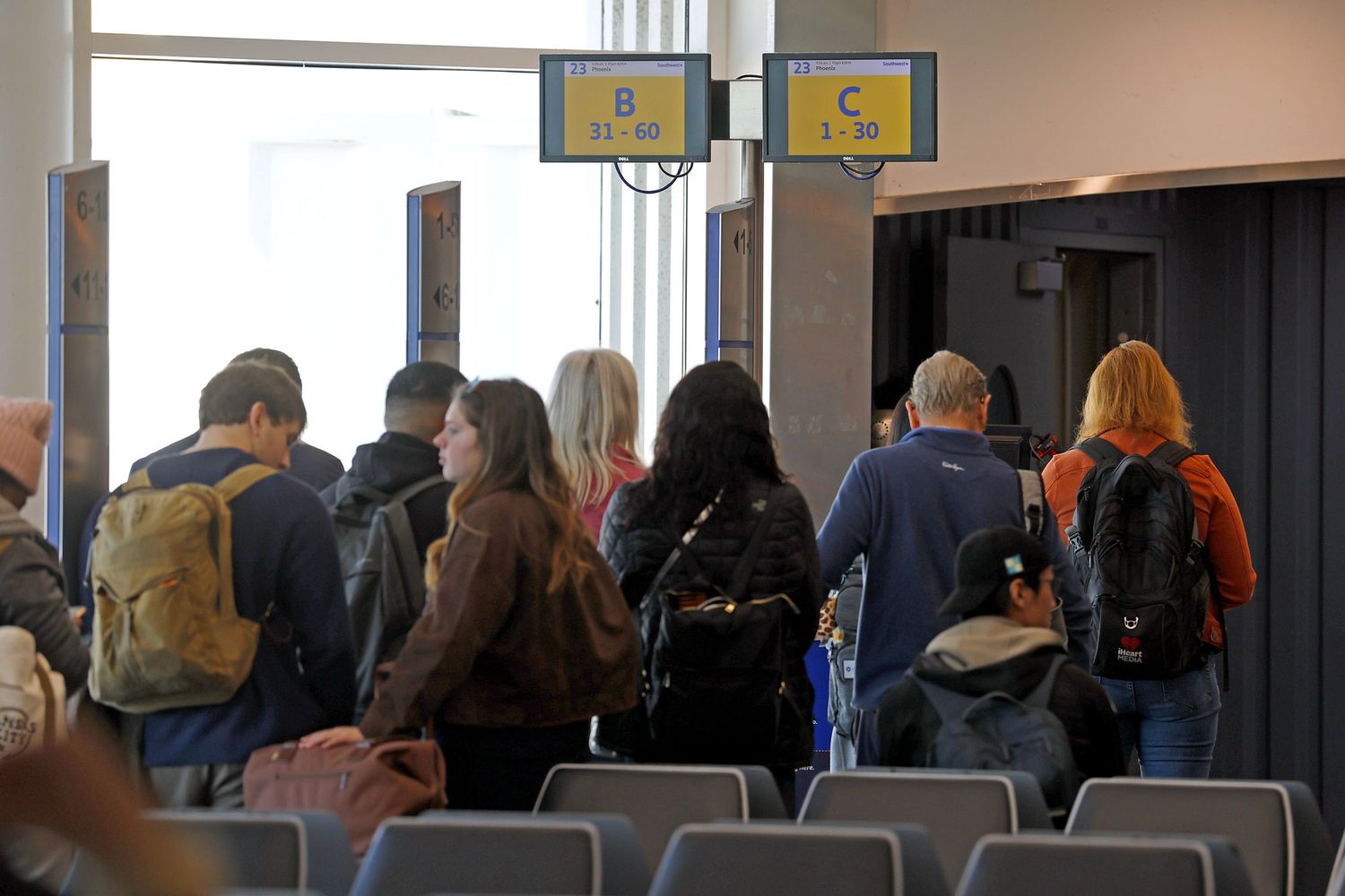 Airport gate with waiting passengers